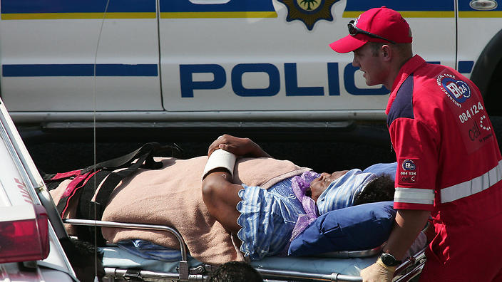 Sekai Holland wheeled away on an ambulance stretcher 22 March 2007 (Getty)